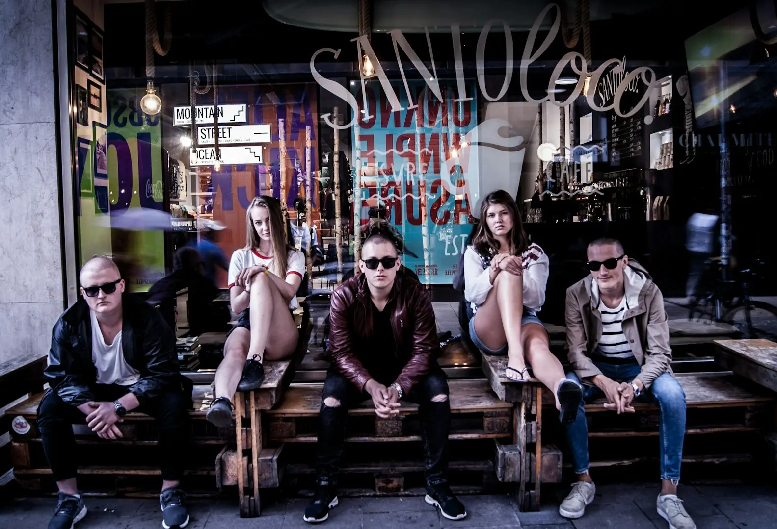 group of people sitting in front of store